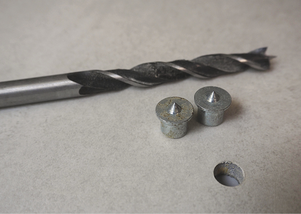 2 Use 3/8-inch dowel pins and a 3/8-inch brad-point drill bit to create holes in the tile that will be compatible with a wheel head.