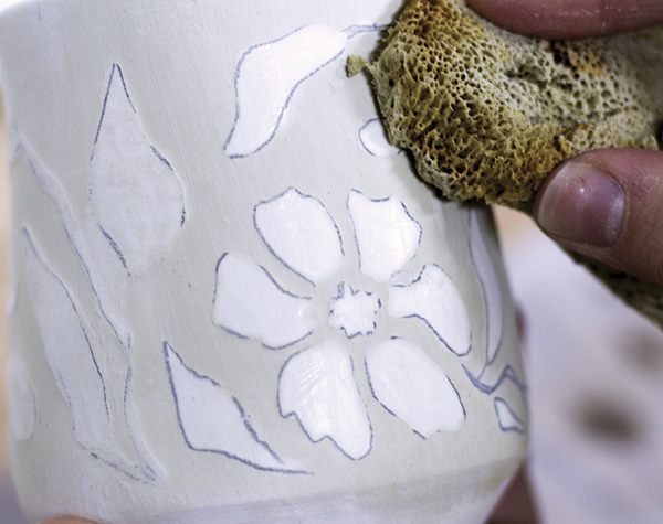 3 Use a damp sponge to gently wipe the surface of your clay.