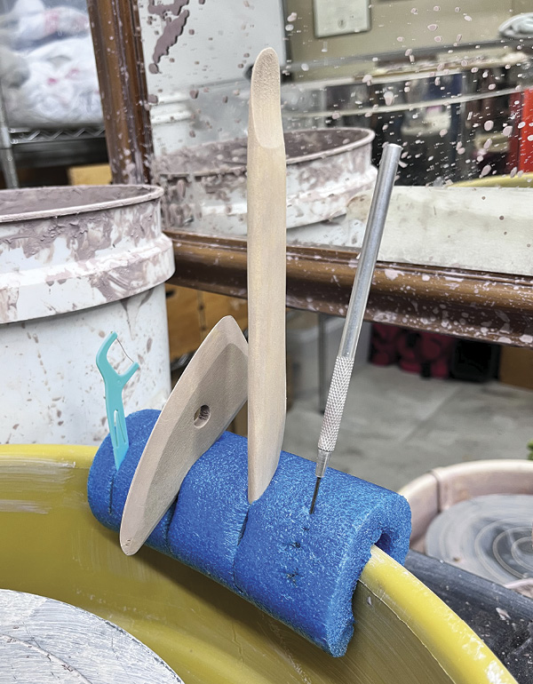 2 A cut section of pool noodle keeps throwing tools organized at the wheel.