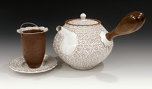 2 Matt Hiller's Wood Handled Floral Teapot with Infuser, to 8¾ in. (22.2 cm) in width, wheel-thrown and carved red stoneware, glaze, fired to cone 5, walnut wood, copper wire, 2025.