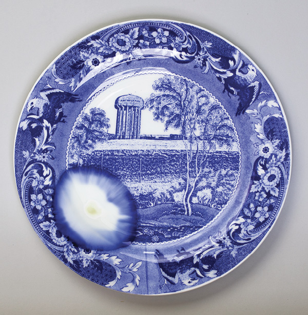 2 Paul Scott’s Flint, near Detroit, No. 4, from the series Cumbrian Blue(s), New American Scenery, bone china plate by Royal Worcester (English, est. 1751), transfer print collage, melted lead, 2020.