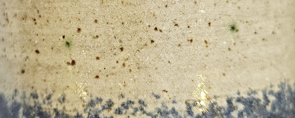 4 Green specking of copper/iron sulfide (chalcopyrite) found in fireclay clay body.