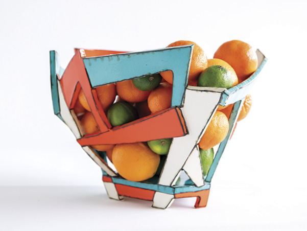 1 Nikki Blair’s turquoise/orange/white basket (with fruit), 12 in. (30 cm) in height, handbuilt white earthenware, Amaco Velvet underglazes, 2021. Photo: Vanderveen Photographers.