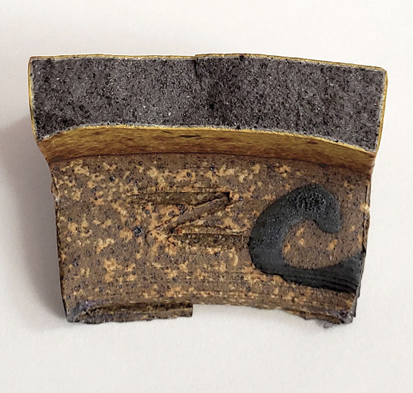 6 A bisection of an over-reduced clay body revealing black to dark gray interior.