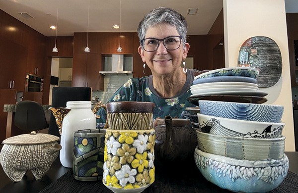 Louise Rosenfield with a selection of collected pottery.