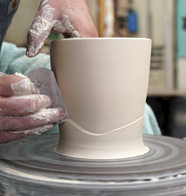 1 Throw a thick cylinder, adding a rib line and leaving clay at the bottom.