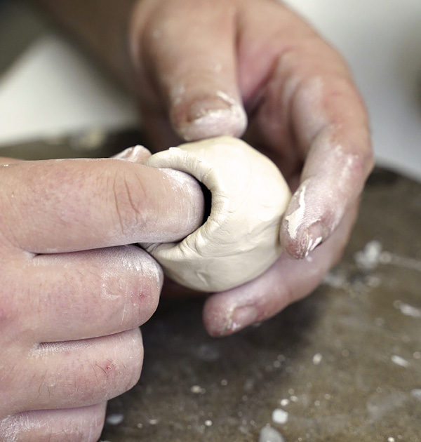 13 With a small ball of clay, pinch out a hollow sphere, trapping air inside.
