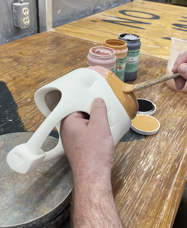 16 Apply two different colors of underglazes to the bisque-fired piece. Once dry, apply a third layer of black and fire again to cone 04.