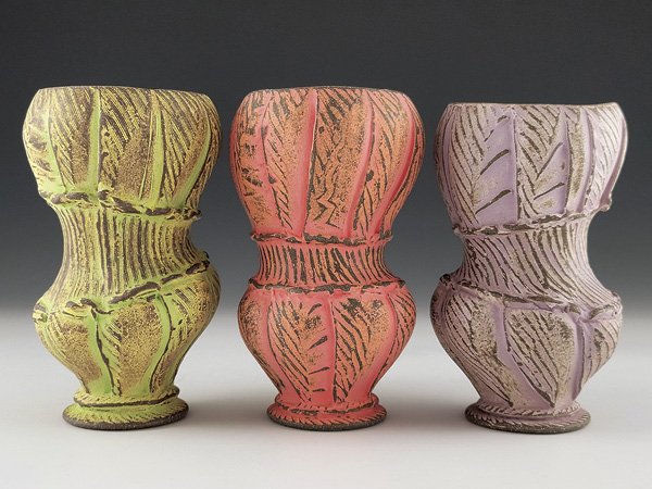 9 Eric Botbyl’s tumblers, 6.8 in. (17.1 cm) in height, wheel-thrown and altered dark stoneware, underglazes, glazes, fired and sanded multiple times, fired in oxidation to cone 6, 2024. Photo: Companion Gallery.