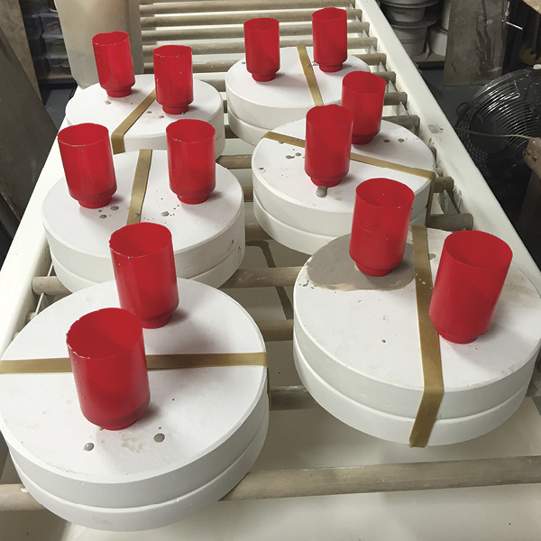 4 Molds set up with modified condiment squirt bottles as a vent and reservoir.