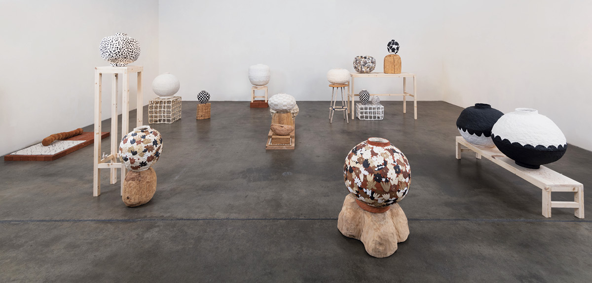 1 Brittany Mojo’s Nowness (installation view), dimensions variable, handbuilt porcelain and stoneware, once fired to mid range in gas kilns, eucalyptus, oak, and pine hand-carved pedestals, found brick, 2021. Part of Mojo’s solo exhibition, “Nowness,” at Craig Krull Gallery, Los Angeles, California. Photo: Mason Kuehler