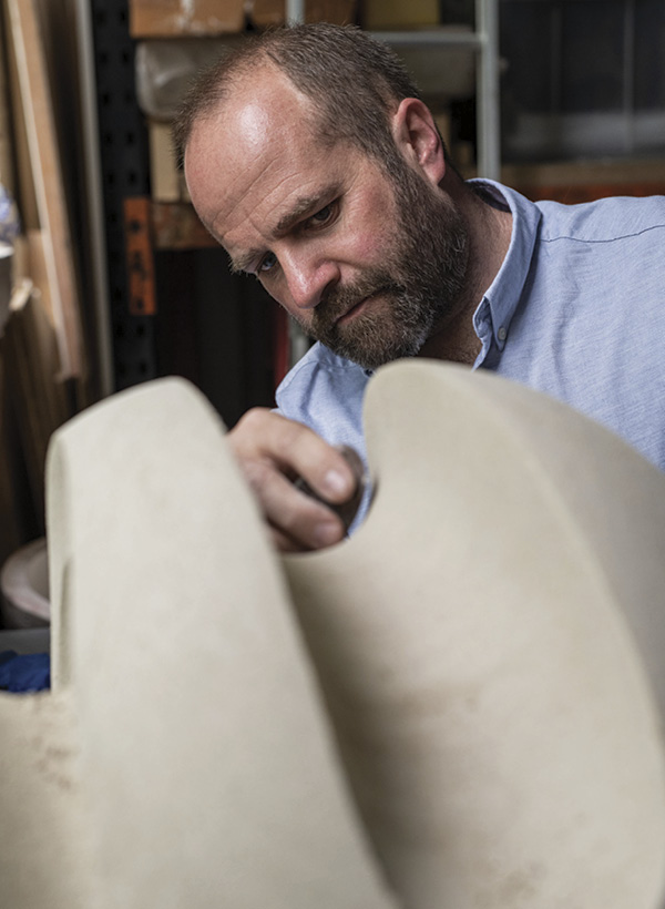 3 James Oughtibridge refining the channels of a sculpture using a serrated metal kidney. Photo: David Fulford.