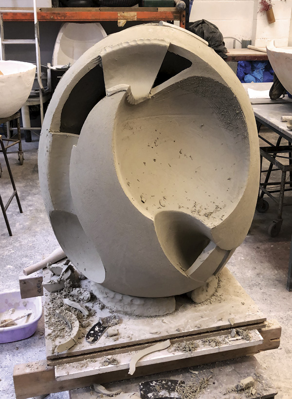 7 James Oughtibridge's Alluvion in construction, shown with the final slabs being inserted, completed in the greenware stage, and safely loaded into the kiln ready to be fired. Alluvion, once fired, was molded and cast in bronze for Hugo Burge.