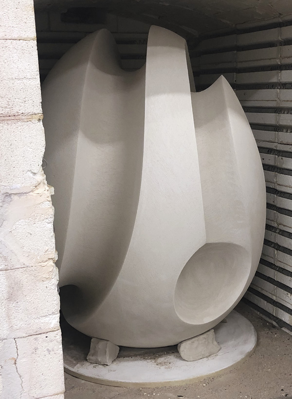 9 James Oughtibridge's Alluvion in construction, shown with the final slabs being inserted, completed in the greenware stage, and safely loaded into the kiln ready to be fired. Alluvion, once fired, was molded and cast in bronze for Hugo Burge.
