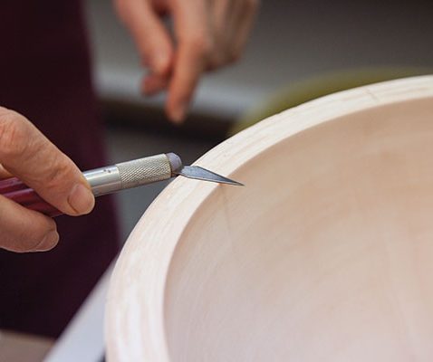5 (alternate view) Trim the top using a modified knife that allows the blade to be held flush with the top of the mold.