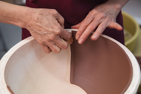 6 Score a line through the excess clay along the edge of the slab then remove it.