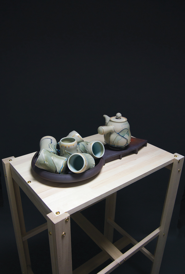 Man-Ho Cho’s White-Teapot-Construction-Base, 3 ft. 6 in. (1 m) in height, porcelain, black stoneware, multiple glazes, wood, 2015.