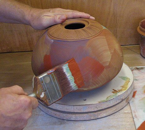 1 Brush on colored clays, then burnish.