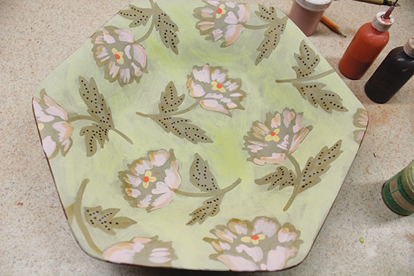13 Apply a layer of wax resist over the patterns to protect them, then apply an overall layer of underglaze for the background