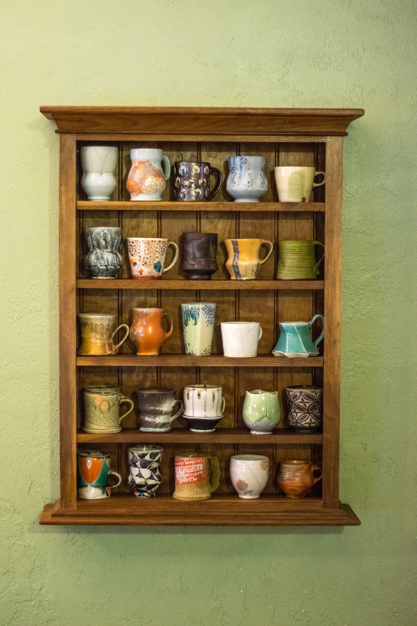 1 Cup shelf in Matt Schiemann’s home, featuring work by the following  (left to right, top to bottom): Adam Field, Jen Allen, Bandana Pottery, Kristen Kieffer, Josh Stover. Eric Botbyl, Kari Radasch, Ted Neal,Tom Jaszczak, Sunshinie Cobb. Linda McFarland, Tara Wilson, Julia Galloway, Steve Godfrey, Gay Smith. Nick Joerling, Matt Long, Lorna Meaden, Jeff Campana, Forrest Lesch-Middelton. Charity Davis Woodard, David Bolton, Tim Kowalczyk, Ben Carter, Simon Levin.