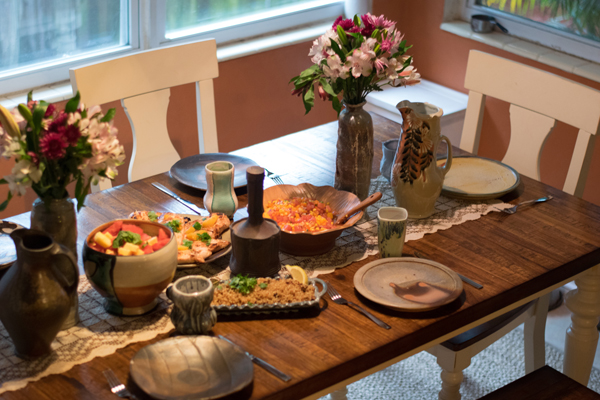 4 The table with handmade pots at each place setting, as well as for serving the meal.