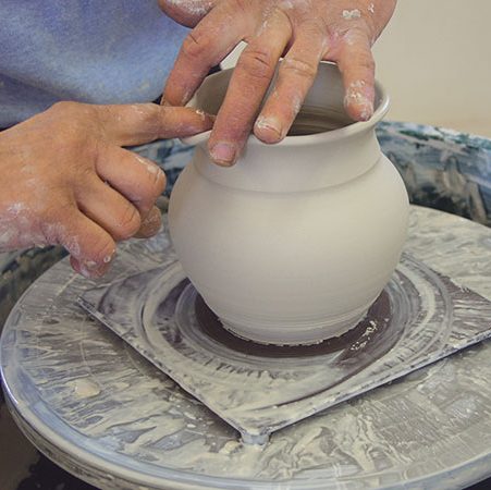 5 Create a dip in the rim by placing two fingers on the outside of the rim and pulling the lip out between them.
