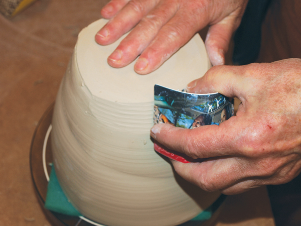 3 Hand trimming a vessel with a Surform.