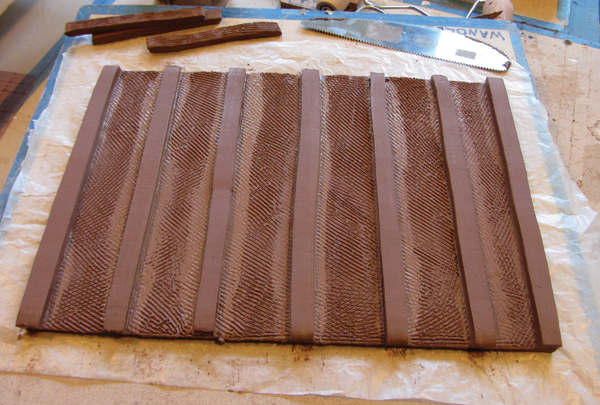 4 Add feet to the bottoms of trays larger than 10 inches square. Place the feet about 1 inch apart.
