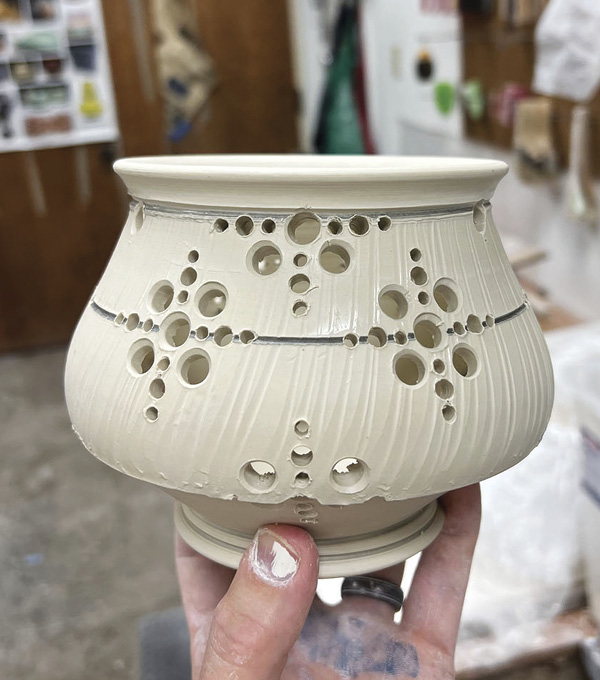 4 After segmenting the teapot body, use a variety of drill bits to create symmetrical patterns around the entire form.