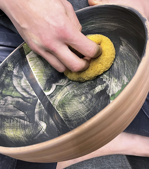 5 Apply a layer of black underglaze wash, then gently wipe away, leaving as much or little as you like. Fully dry the pot.