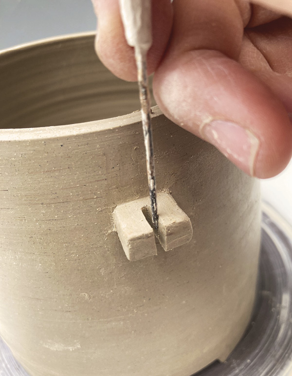 14 After it is attached, cut a deep notch in the middle of the second lug.