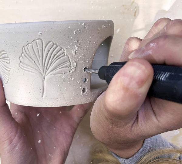 9 Drill airflow holes with a rotary tool to allow air to circulate within the form, keeping your candle lit.