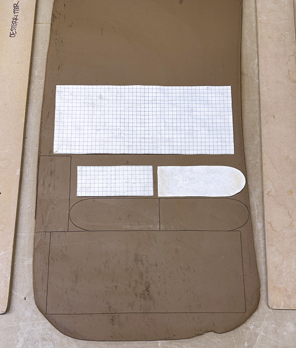 1 Roll out a 1/4-inch (6.4-cm) thick slab large enough to cut pieces for several forms. Use the surface area efficiently to avoid waste.