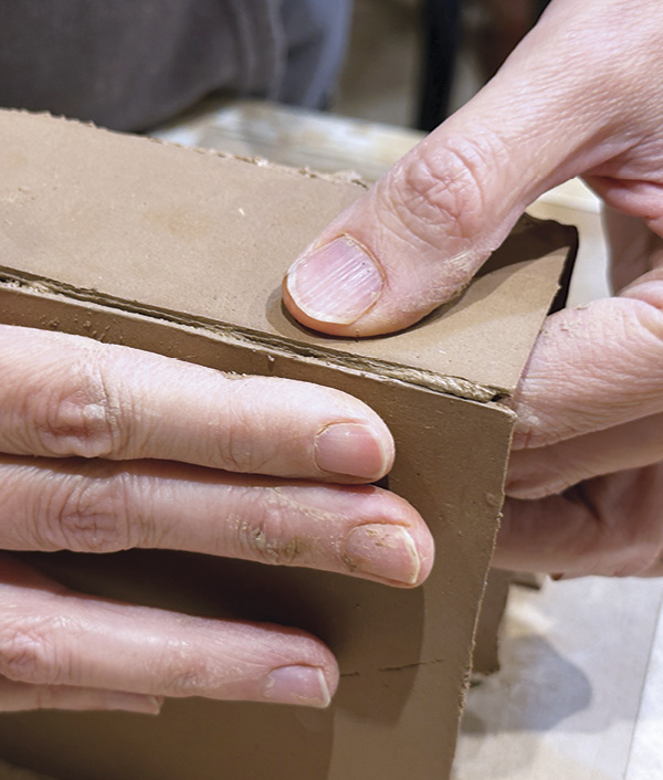 5 While supporting both slabs, press the slipped pieces firmly together until a bead of mortar slip oozes from the seam.