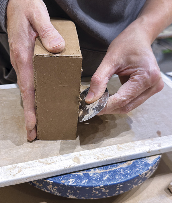 8 Score, slip, and attach the final slab. True the edges and clean the outside of the form with a metal rib.