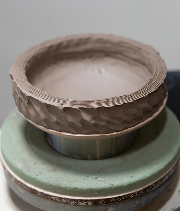 4 After cutting off the top of the coils, score but wait to slip until you are ready to attach the two sides of the vase together.
