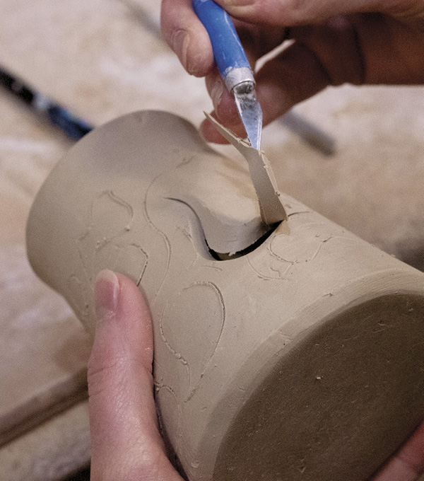 3 Use an X-Acto knife to lift cutouts from the wall. Carving negative and positive shapes creates visual depth.