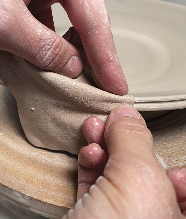 10 Compress the edge with a wet chamois, using your thumbnail to split the rim.