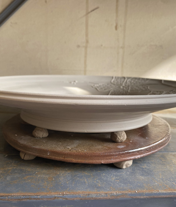 18 The plate is fired on a cookie and rests on small balls of wadding.