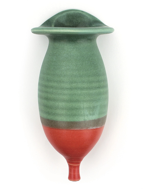 Sarah Gelsanliter's green and coral-red wall pocket, 8 in. (20.3 cm) in height, thrown-and-altered stoneware, fired in oxidation to cone 5, 2025.