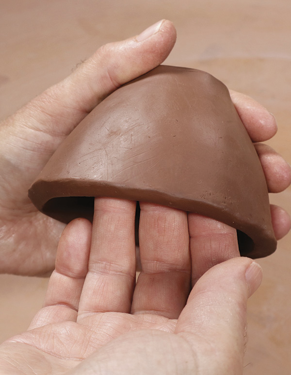 9 Add volume to the pedestal by pushing the clay out with your fingers or a rib.