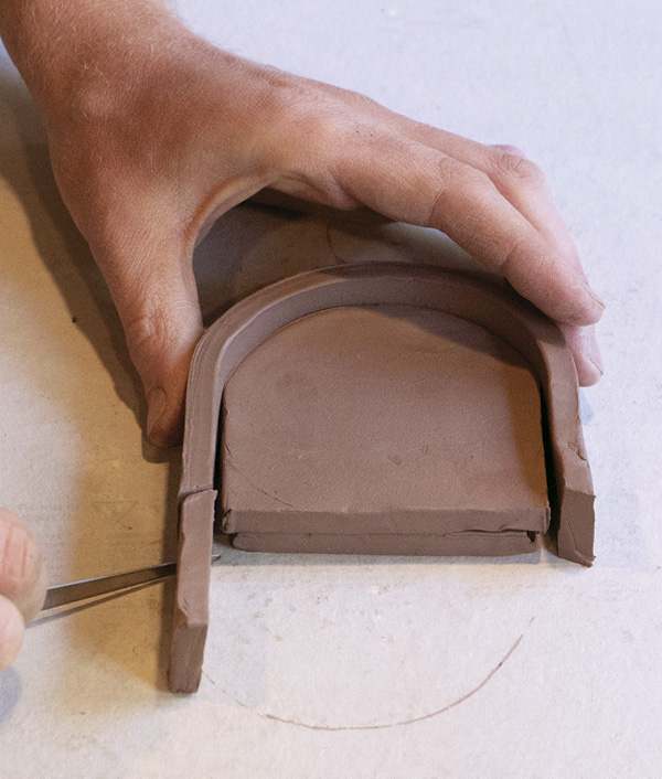 7 Dry fit and cut the tray rim at an angle to meet the sconce face.