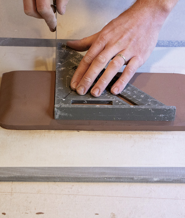 8 Use a speed square to mark a straight line for the tray to be attached.