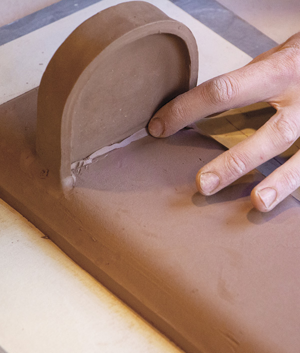 9 Attach the tray. Add a small clay coil to fill in the seam.