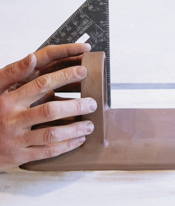 11 Confirm that the tray is perpendicular to the sconce back with the speed square.