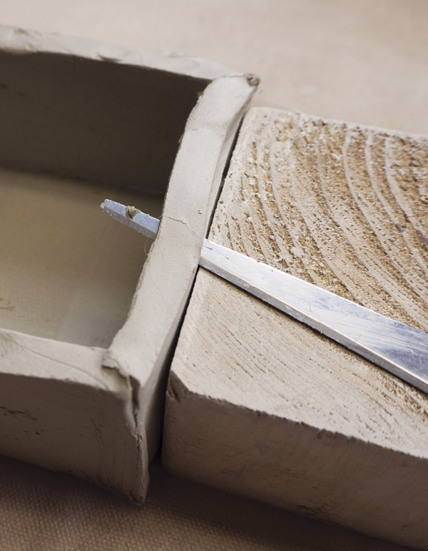 9 Use the wood block as a guide to square up the top edge of the form.