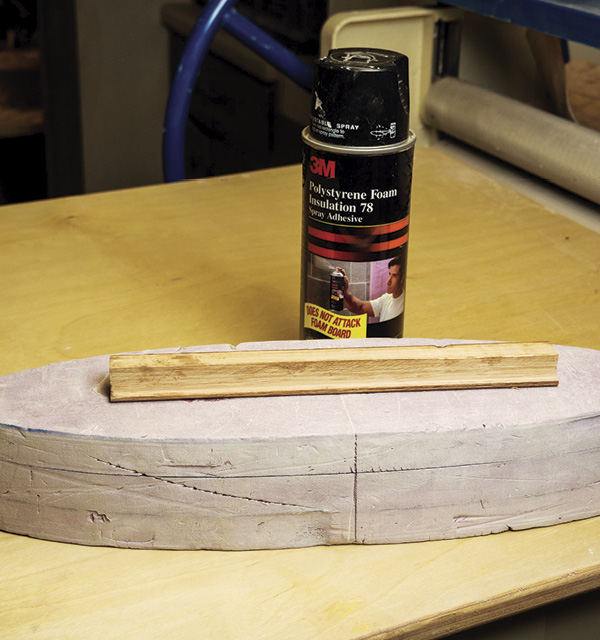 2 Stack the foam pieces, then glue them together with spray foam adhesive.