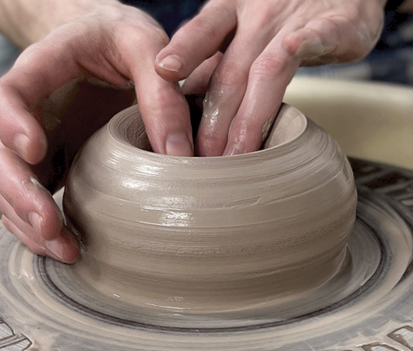 2 Opening the clay at an angle to help you control the rim.