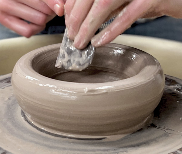 3 Use a right-angled rib to compress the base and set the corner.