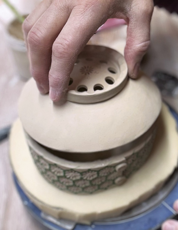 11 Add the bowl to the top, then join them by gently tapping with a paddle.